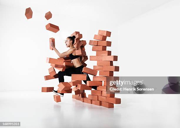 runner shattering barrier - single brick stock pictures, royalty-free photos & images