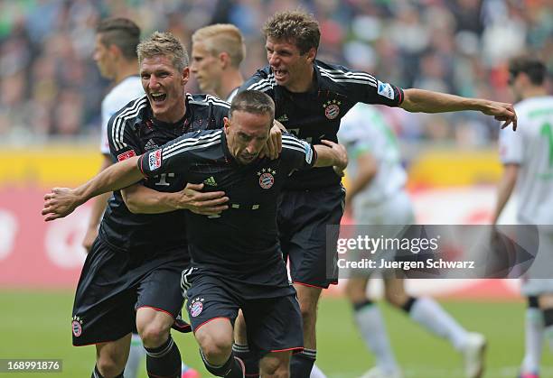 Franck Ribery of Munich celebrates with Bastian Schweinsteiger and Thomas Mueller after scoring during the Bundesliga match between Borussia...