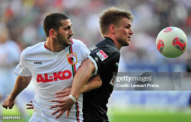 Sascha Moelders of Augsburg challenges Florian Trinks of Fuerth during the Bundesliga match between FC Augsburg and SpVgg Greuther Fuerth at SGL...