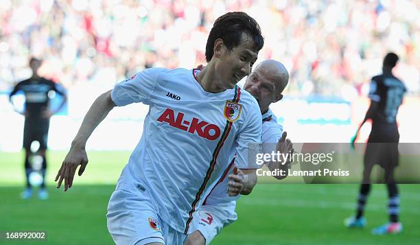 Dong-Won Ji and Tobias Werner of Augsburg celebrate the third goal during the Bundesliga match between FC Augsburg and SpVgg Greuther Fuerth at SGL...