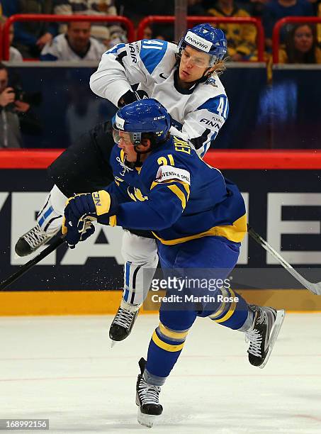 Antti Pihlstrom of Finland and Loui Eriksson of Sweden battle for the puck during the IIHF World Championship semifinal match between Finland and...