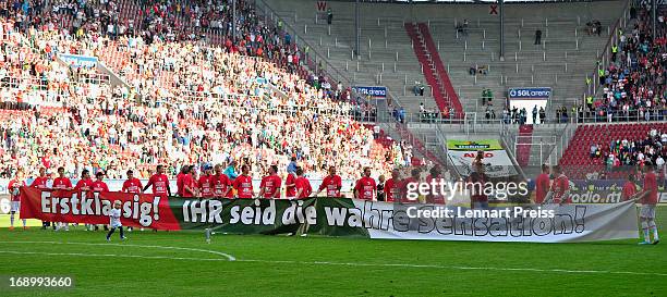 The team of Augsburg displays a banner after the Bundesliga match between FC Augsburg and SpVgg Greuther Fuerth at SGL Arena on May 18, 2013 in...