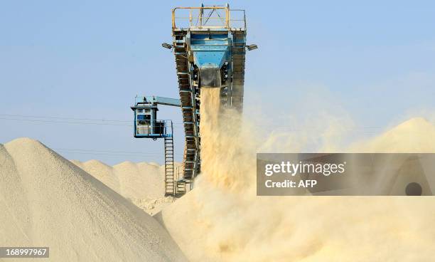 This picture taken on May 13, 2013 shows untreated phosphate being dropped off on a montain at the end of a conveyor belt at the Marca factory of the...