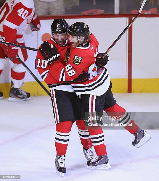 Patrick Sharp and Patrick Kane of the Chicago Blackhawks celebrate Kanes' first goal of the playoffs in the first period against the Detroit Red...