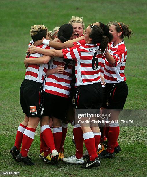 Bethany England of Doncaster Rovers Belles Ladies FC is mobbed by her team-mates after scoring her side's first goal during the FA WSL Continental...