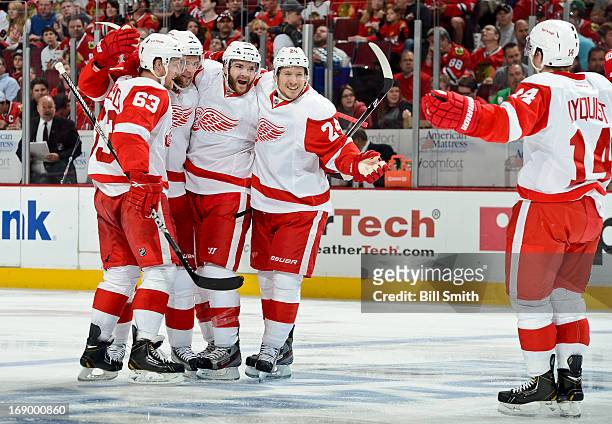 Gustav Nyquist of the Detroit Red Wings skates in to celebrate with teammates Joakim Andersson, Jakub Kindl, Carlo Colaiacovo and Damien Brunner...