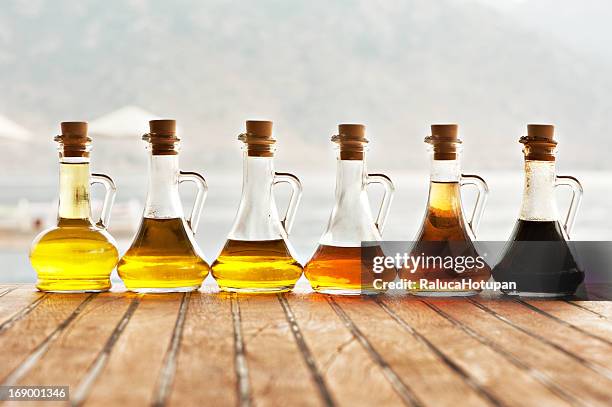 olive oil and vinegar in bottles - vinegar stockfoto's en -beelden