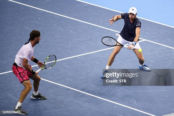 Jamie Murray of Britain hits a return next to partner Michael Venus of New Zealand during their men's doubles final match against Nathaniel Lammons...