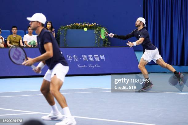 Nathaniel Lammons of the US hits a return beside partner Jackson Withrow of the US during their men's doubles final match against Jamie Murray of...