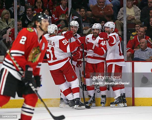 Valtteri Filppula, Brendan Smith, Henrik Zetterberg and Daniel Cleary of the Detroit Red Wings celebrate a second period goal as Duncan Keith of the...