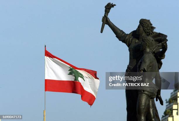Lebanese flag flies near the bullet riddled Martyrs Statue in downtown Beiut near the grave of slain former Lebanese premier Rafiq Hariri 26 March...