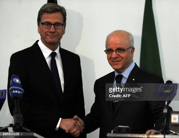 German Foreign Minister Guido Westerwelle and Algerian Foreign Minister Mourad Medelci shake hands during a joint press conference in the capital...