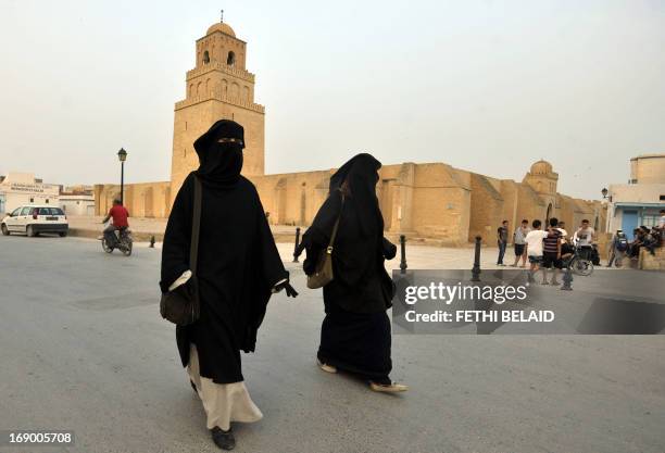 Tunisian salafi women walk in front of Okba Ibn Nafaa mosque in the city of Kairouan on May 18, 2013. Security forces deployed in numbers after...