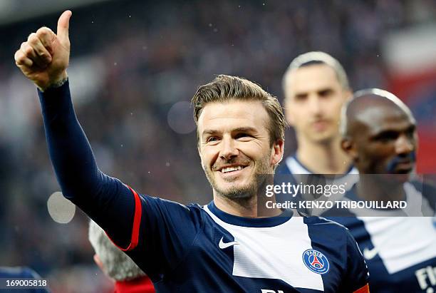 Paris Saint-Germain's English midfielder David Beckham gives a thumbs up during a French L1 football match between Paris St Germain and Brest on May...