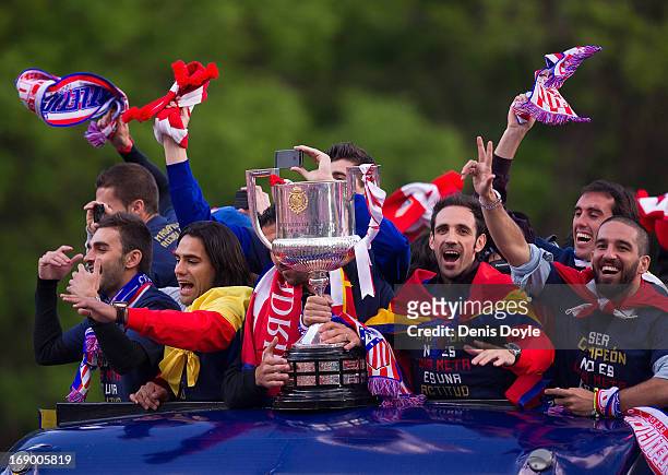 Juan Francisco 'Juanfran' Adra Turan and Radamel Falcao of Atletico de Madrid celebrate from an open-top bus a day after winning the Copa del Rey...