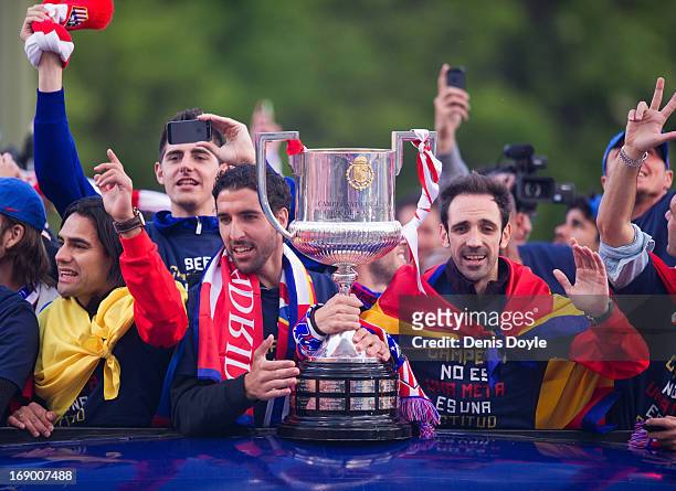 Raul Garcia Jand uan Francisco 'Juanfran' of Atletico de Madrid celebrate with the trophy from an open-top bus a day after winning the Copa del Rey...
