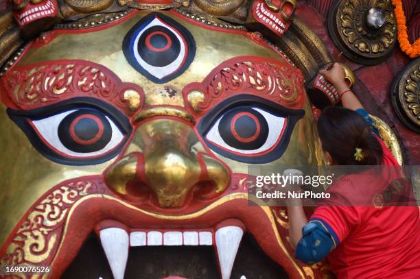 Nepalese devotee cleans the huge mask of idol Swet Bharab on the first day of Indra Jatra Festival celebrated in Basantapur Durbar Square, Kathmandu,...