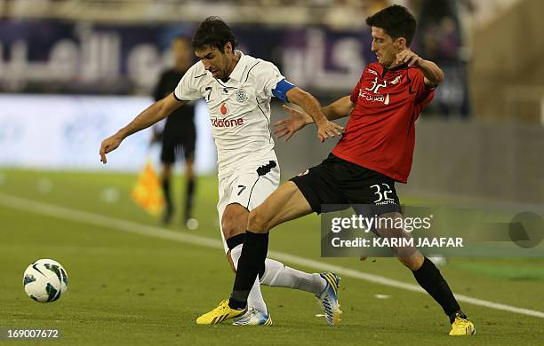 Al-Sadd's Spanish forward Raul fights for the ball with Al-Ryyan's Uruguayan midfielder Alvaro Fernandez during their Emir Cup soccer tournament...