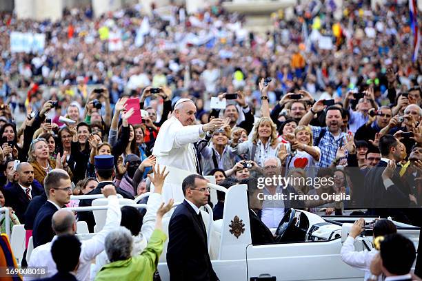 Pope Francis waves to faithful as he arrives in St. Peter's Square for the celebration of Pentecost Vigil with lay Ecclesial movements on May 18,...