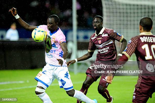 Evian's Ghanaian midfielder Mohammed Rabiu vies for the ball with Valenciennes' Senegalese midfielder Remi Gomis during the French L1 football match...