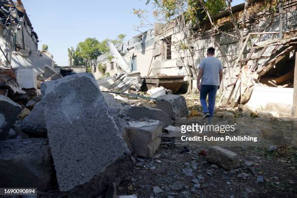 Man walks on the ruins of an industrial goods production shop destroyed by the falling Russian missile debris, Odesa, southern Ukraine. As reported,...