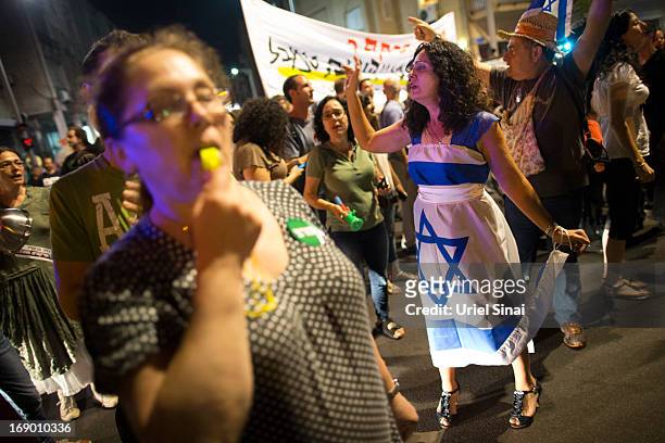 Demonstrators march through the streets to protest against Israeli Finance Minister Yair Lapid's budget cuts on May 18, 2013 in Tel Aviv, Israel....