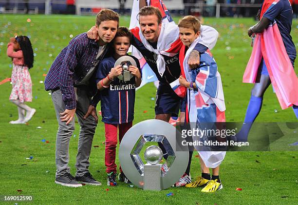 David Beckham poses wih the Ligue 1 trophy and his sons, Brooklyn, Romeo and Cruz during the Ligue 1 match between Paris Saint-Germain FC and Stade...