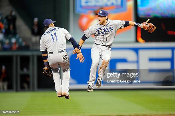 Yunel Escobar and Ben Zobrist of the Tampa Bay Rays celebrate after a 10-6 victory against the Baltimore Orioles at Oriole Park at Camden Yards on...