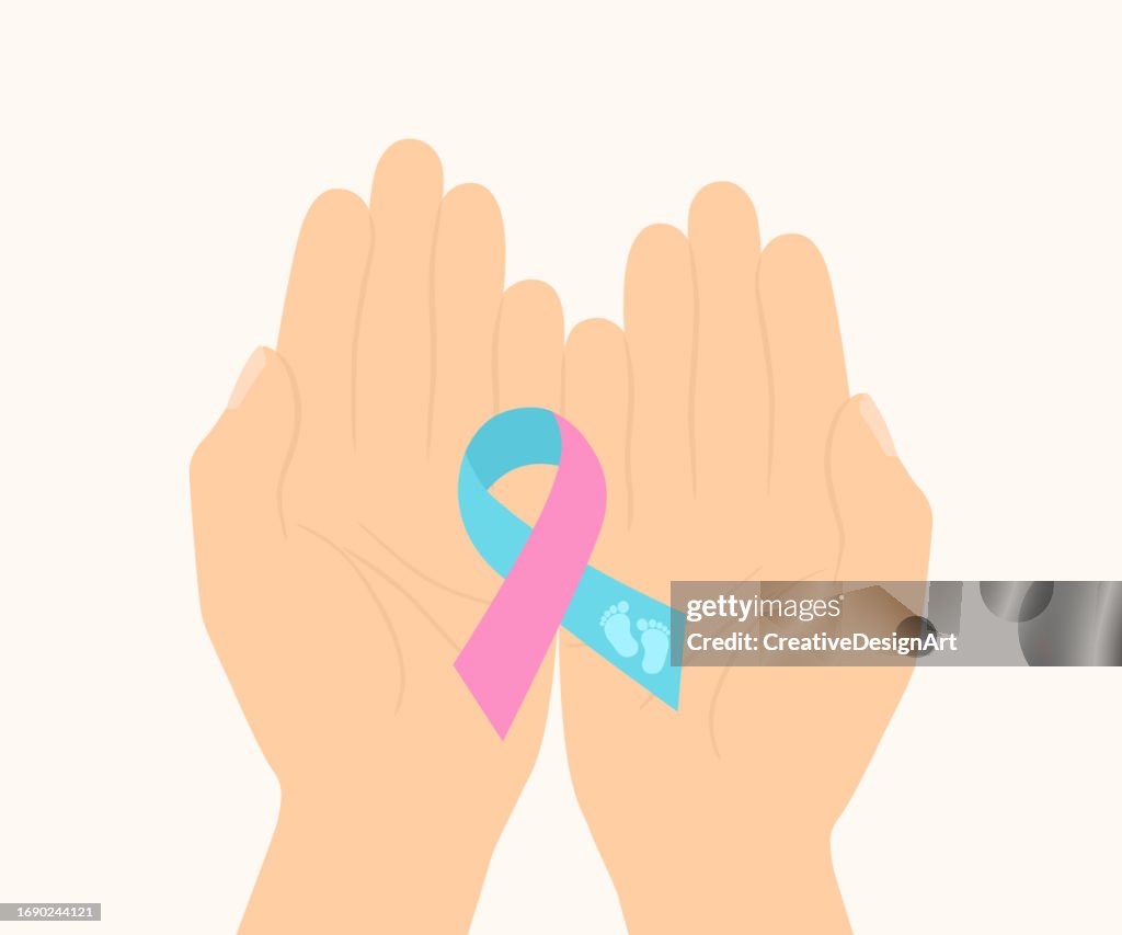 Pregnancy And Infant Loss Awareness Month Concept. Hand Holding Pink Blue Awareness Ribbon With Baby Footprint