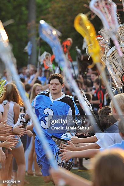 Brett Garber of the Ohio Machine takes the field past a gauntlet of young fans and their lacrosse sticks before a game against the New York Lizards...