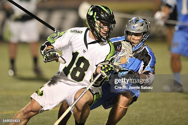 Stephen Peyser of the New York Lizards controls the ball in the fourth period as Kyle Hartzell of the Ohio Machine defends on May 18, 2013 at Selby...