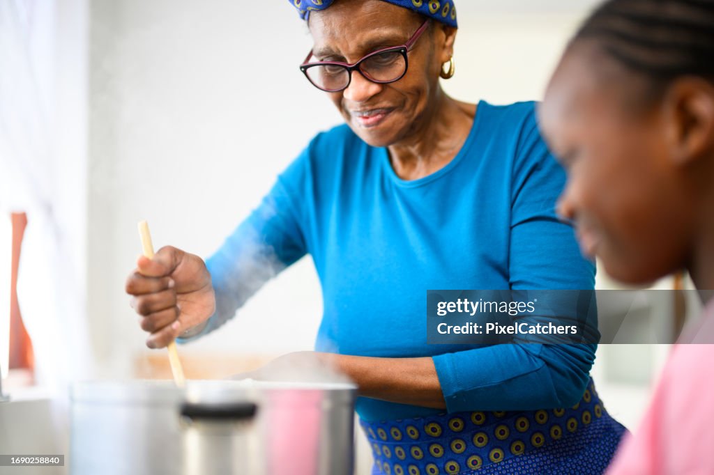 Close up grandmother wearing traditional clothes stirring pot