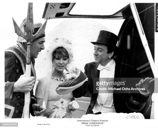 Jean-Pierre Cassel and Irina Demick in wedding attire with in a scene from the film 'Male Companion', 1964.