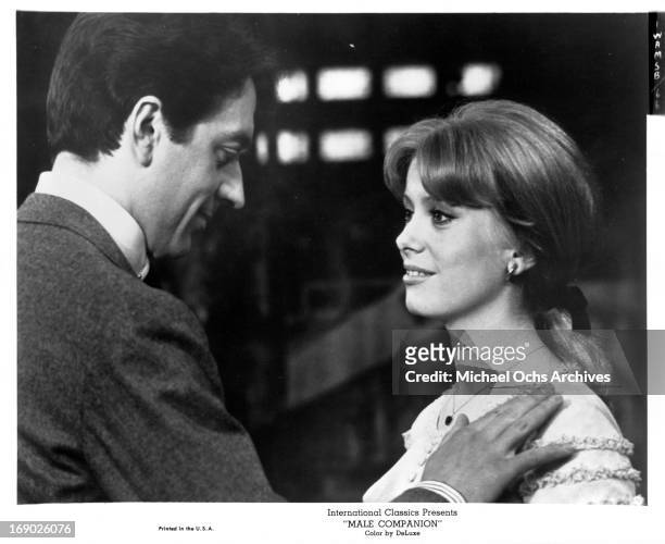 Jean-Pierre Cassel with his hand on Irina Demick as they look into one an others eyes in a scene from the film 'Male Companion', 1964.