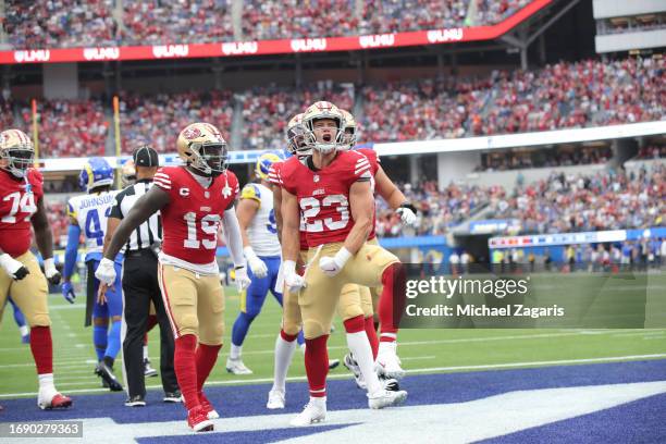 Christian McCaffrey of the San Francisco 49ers celebrates after rushing for a 14-yard touchdown during the game against the Los Angeles Rams at SoFi...