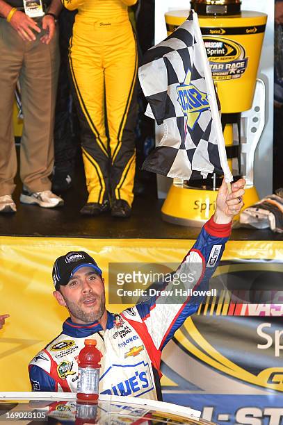 Jimmie Johnson, driver of the Lowe's Patriotic Chevrolet, celebrates in Victory Lane after winning the NASCAR Sprint Cup Series All-Star race at...
