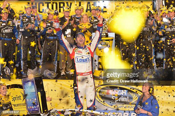 Jimmie Johnson, driver of the Lowe's Patriotic Chevrolet, celebrates in Victory Lane after winning the NASCAR Sprint Cup Series All-Star race at...
