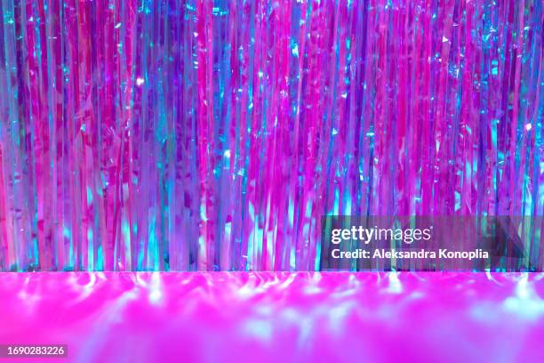 trendy retro 80's, 90's disco party backdrop - abstract empty stage with sparkling holographic pink tinsels and magenta pink background. pastel holographic neon colors. - stage decoration stock pictures, royalty-free photos & images