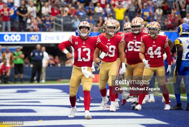 Brock Purdy of the San Francisco 49ers celebrates after rushing for for a 1-yard touchdown during the game against the Los Angeles Rams at SoFi...