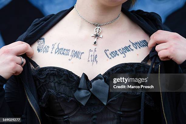 Woman shows her tattoo 'Don't dream your life - Live your dreams' on the second day of the annual Wave-Gotik Treffen, or Wave and Goth Festival, on...