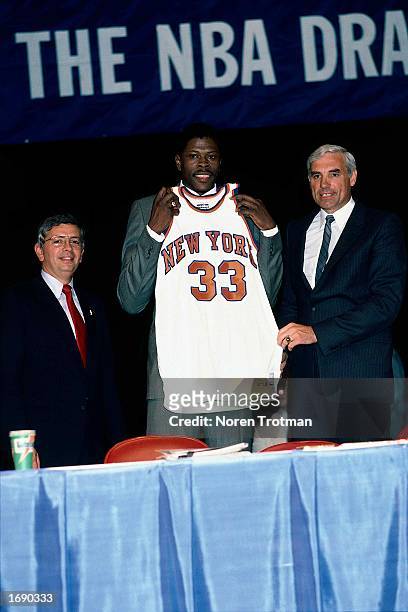 Patrick Ewing of the New York Knicks poses for a portrait with the Knicks General Manager Dave DeBusschere and NBA Commissioner David Stern during...