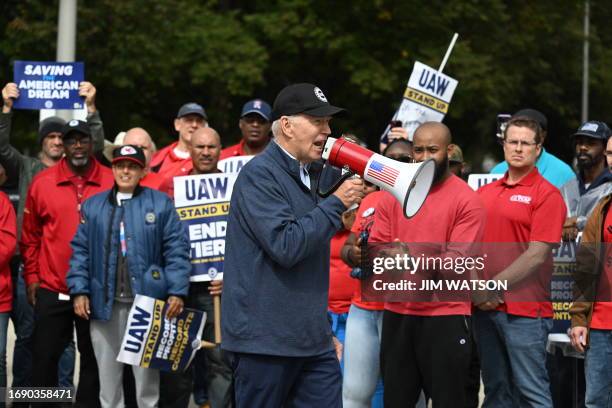 President Joe Biden addresses striking members of the United Auto Workers union at a picket line outside a General Motors Service Parts Operations...