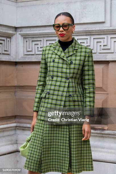 Nadine Ijewere wears green checkered blazer, skirt outside Emilia Wickstead during London Fashion Week September 2023 at the on September 18, 2023 in...