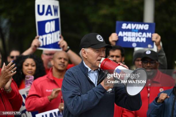 President Joe Biden addresses striking members of the United Auto Workers union at a picket line outside a General Motors Service Parts Operations...