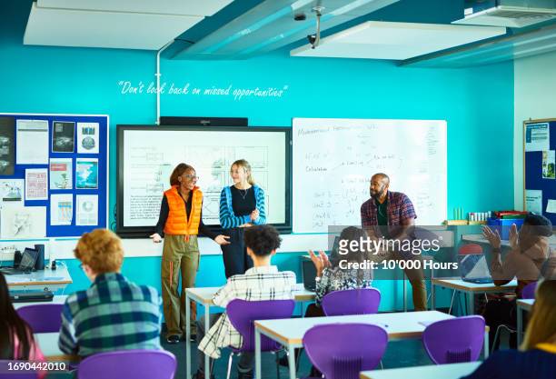 two female students presenting project to class in technical college - england training session stock pictures, royalty-free photos & images