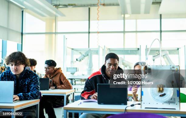 black male student and asian student using laptop in technical college class - orthographic symbol stock pictures, royalty-free photos & images