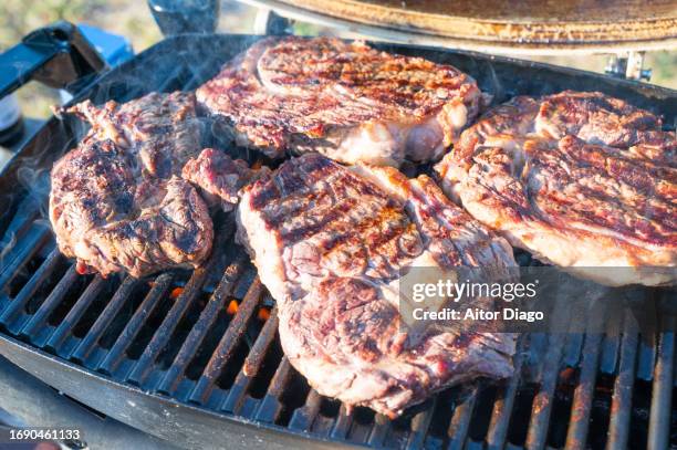 cooking on a charcoal barbecue beef meat. - burnt steak stock pictures, royalty-free photos & images