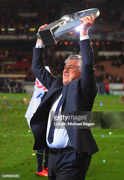 Manager Carlo Ancelotti celebrates with the Ligue 1 trophy after the Ligue 1 match between Paris Saint-Germain FC and Stade Brestois 29 at Parc des...