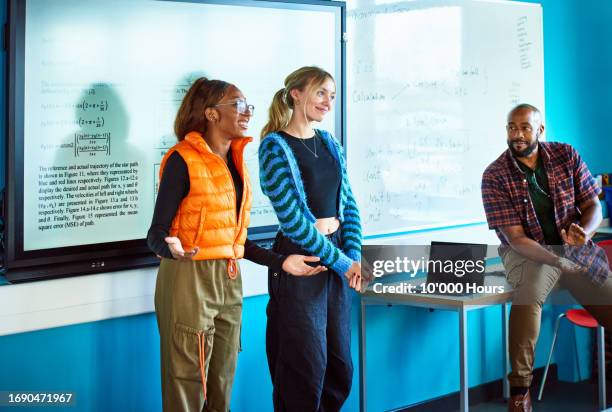 two college students presenting project to class - whiteboard visual aid stock pictures, royalty-free photos & images