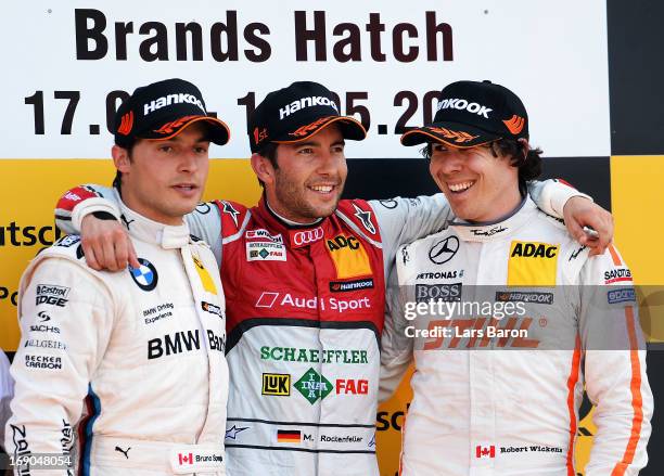 Mike Rockenfeller of Germany Audi Sport Team Phoenix celebrates with second placed Bruno Spengler of Canada and BMW Team Schnitzer and third placed...